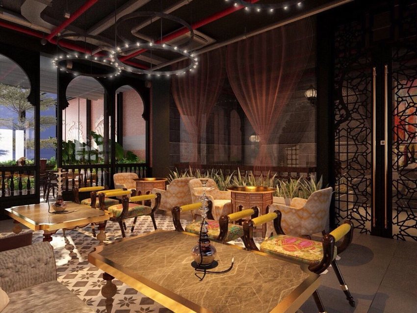 Thiết kế quán cafe phong cách Á Đông sang trọng, bàn đá và ghế gỗ bọc nệm hoa văn, không gian kết hợp đèn trần hiện đại và trang trí hookah.