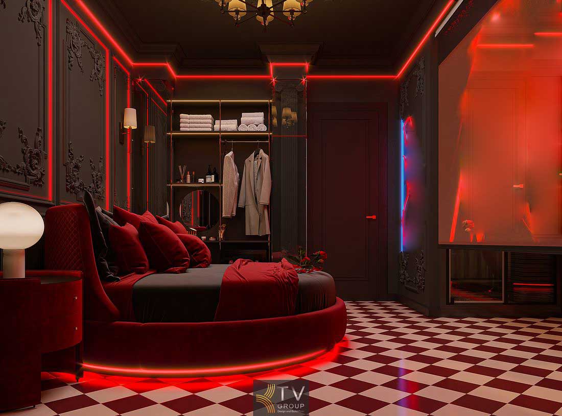 Không gian phòng khách sạn với ánh sáng đỏ nổi bật, nội thất bo cong và vật liệu cao cấp mang lại cảm giác ấm áp và tinh tế