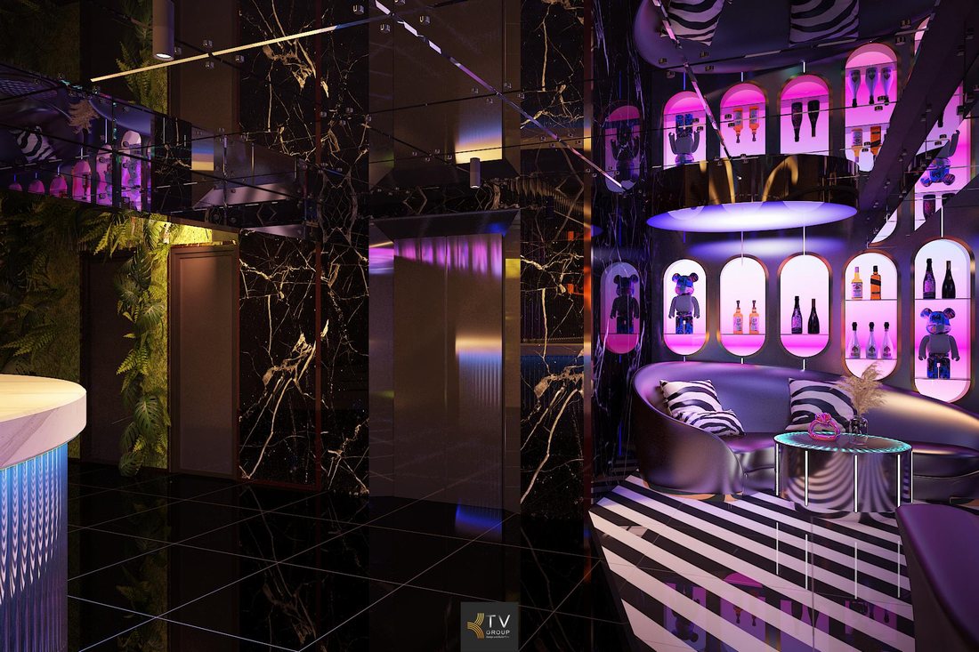 Không gian lobby karaoke phong cách futuristic với trần ánh sáng oval, tường trang trí độc đáo và nội thất hiện đại thu hút khách check-in.