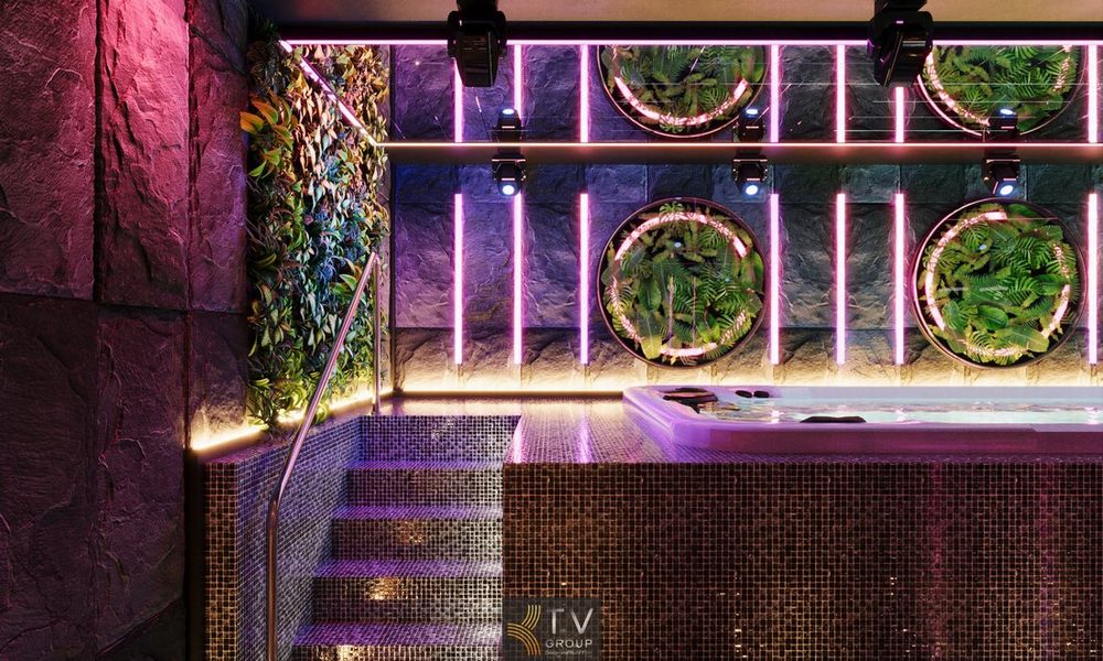 Mẫu thiết kế thi công spa massage kết hợp karaoke với ánh sáng tím neon nổi bật, sàn họa tiết hình học và nội thất cao cấp phù hợp mô hình kinh doanh giải trí VIP tại trung tâm