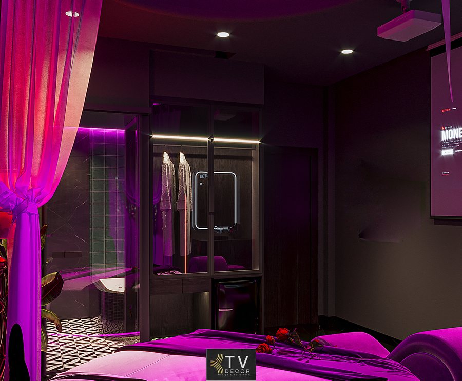 Phòng khách sạn chủ đề lãng mạn sắc tím Neon do KTV GROUP thiết kế, nổi bật giường tròn, ánh sáng LED đa lớp và bố cục ấn tượng.