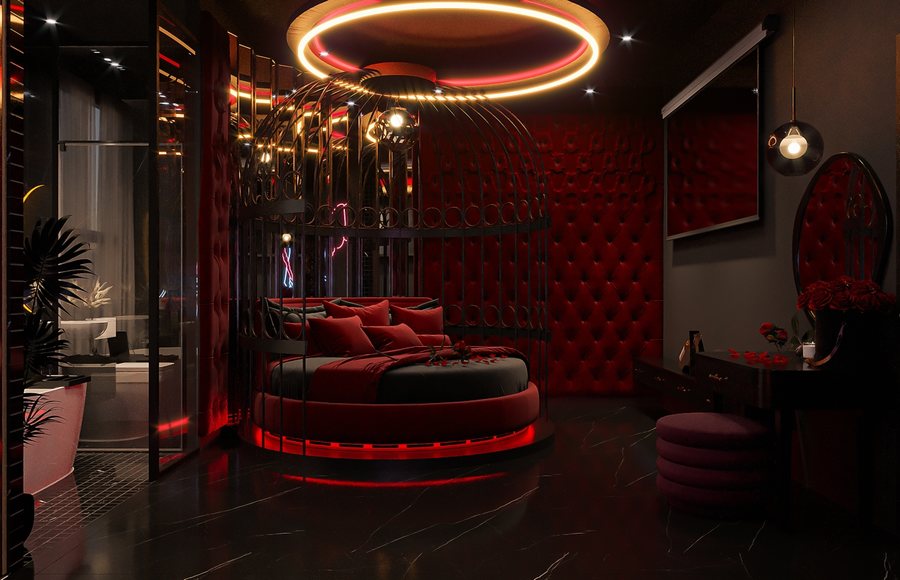 Phòng khách sạn tình yêu phong cách hiện đại với giường tròn, khung trang trí cao cấp và ánh sáng đỏ ấm tạo không gian độc đáo