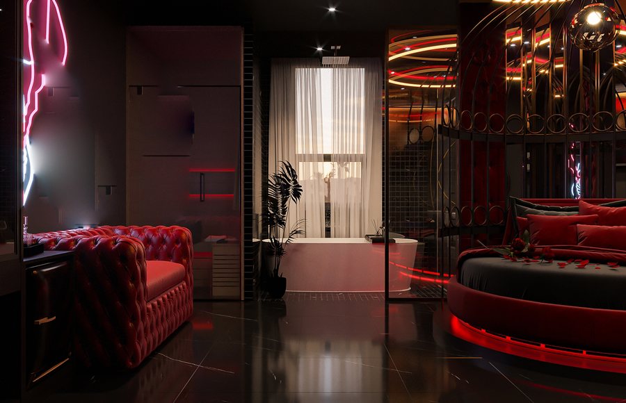 Thiết kế phòng khách sạn chủ đề tình yêu hiện đại, gam màu đỏ – đen sang trọng, giường tròn độc đáo và khung trang trí kim loại tạo điểm nhấn ấn tượng.