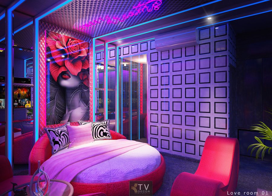 Thiết kế phòng khách sạn Art Neon với giường tròn, ánh sáng đổi màu và tranh tường nghệ thuật nổi bật.