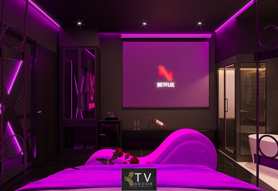 Không gian phòng khách sạn phong cách giải trí neon hiện đại, hiệu ứng ánh sáng tím – đen mạnh mẽ, giường trung tâm và nội thất bọc nệm cao cấp do KTV GROUP thực hiện 2