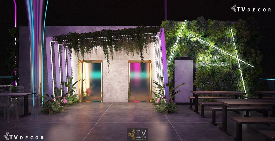 Cổng Beer Garden được thiết kế hiện đại với ánh sáng neon nhiều màu, hai cửa kính mờ viền vàng nổi bật. Mảng tường cây xanh kết hợp đèn LED tạo điểm nhấn nghệ thuật, mang lại cảm giác sang trọng và ấn tượng ngay từ lối vào.