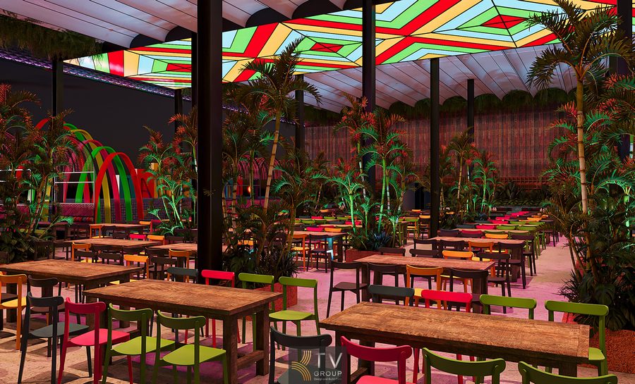 Không gian nhà hàng Coco Garden phong cách Thái nổi bật với bàn ghế gỗ nhiều màu sắc, trần mái họa tiết rực rỡ, cây xanh nhiệt đới bố trí dày, ánh sáng ấm áp, tạo cảm giác sân vườn mở, thư giãn và sinh động cho trải nghiệm ẩm thực kết hợp giải trí.